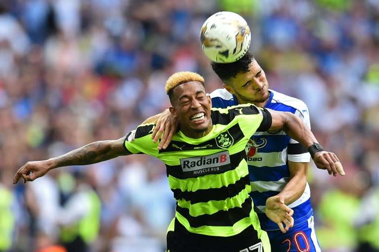Huddersfield Town's midfielder Rajiv van La Parra (L) vies with Reading's Portuguese defender Tiago Ilori during the English Championship play-off final football match between Huddersfield Town and Reading at Wembley Stadium in London on May 29, 2017