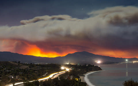 The Thomas Fire rages in Ventura County, as seen from Summerland in Santa Barbara County, The blaze started on Monday evening and spread rapidly overnight to envelop at least 45,000 acres - Credit: Alamy