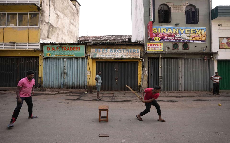 People play cricket on a deserted street at a wholesale market during a countrywide strike in Colombo, Sri Lanka, Friday, May 6, 2022. Protesters have hung undergarments near Sri Lanka’s Parliament while shops, offices and schools closed and transport came to a near standstill amid nationwide demonstrations against the government over its alleged inability to resolve the worst economic crisis in decades. (AP Photo/Eranga Jayawardena)