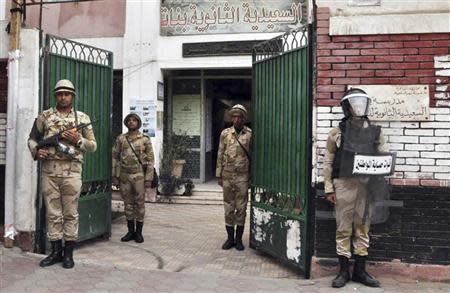 Egyptian soldiers stand guard in the courtyard of a school that will be used as a polling station in downtown Cairo January 13, 2014. REUTERS/Al Youm Al Saabi Newspaper