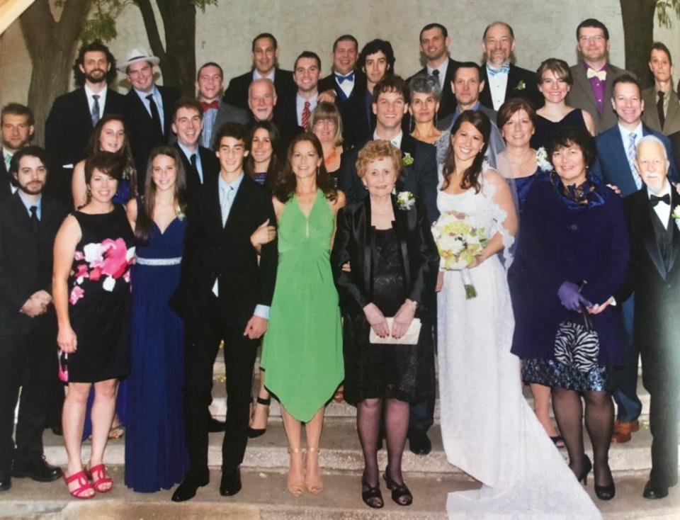 Mary Martelly, 91 in the middle with her late husband Guido Rosario Martelli on the far right, along with her nine children and all her grandchildren.