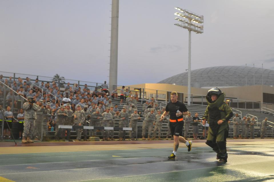 Ashley Sorensen, with the 303rd Explosive Ordnance Disposal Battalion, attempts a new world record by running a mile in 11 minutes, 6 seconds, while wearing a fully functional bomb disposal suit