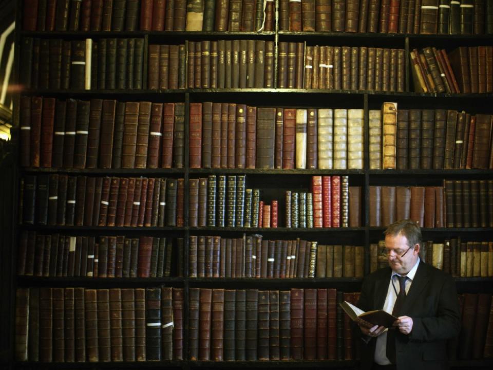 man reading library old antiques