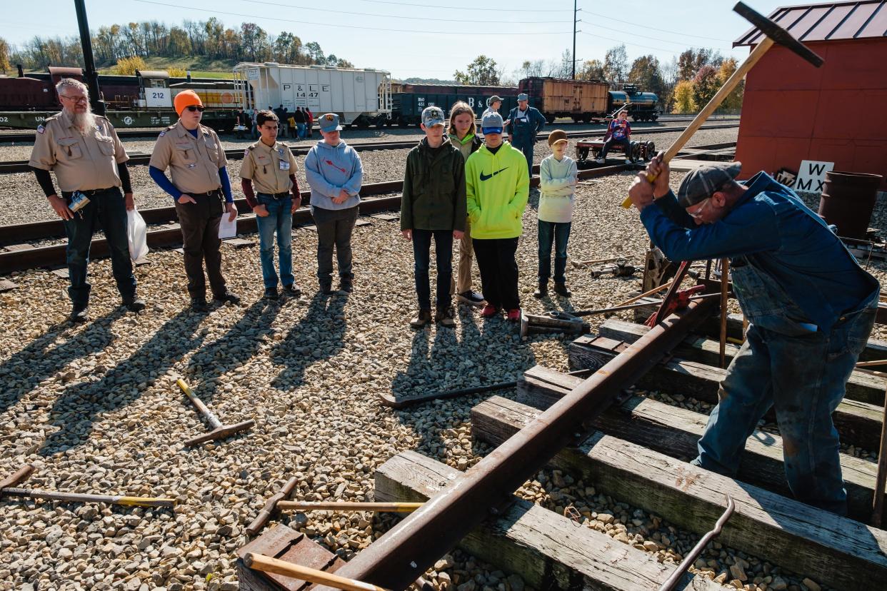 Greg Miller teaches Scouts about track maintenance during the railroad merit badge program at the Age of Steam Roundhouse Museum in Sugarcreek.