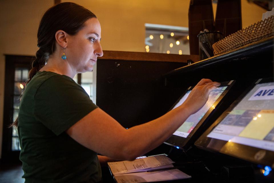 Rachel Gordon enters drink orders into the computer system at Avenue M, February 7, 2023. Gordon has been a server at the restaurant for nearly six years.