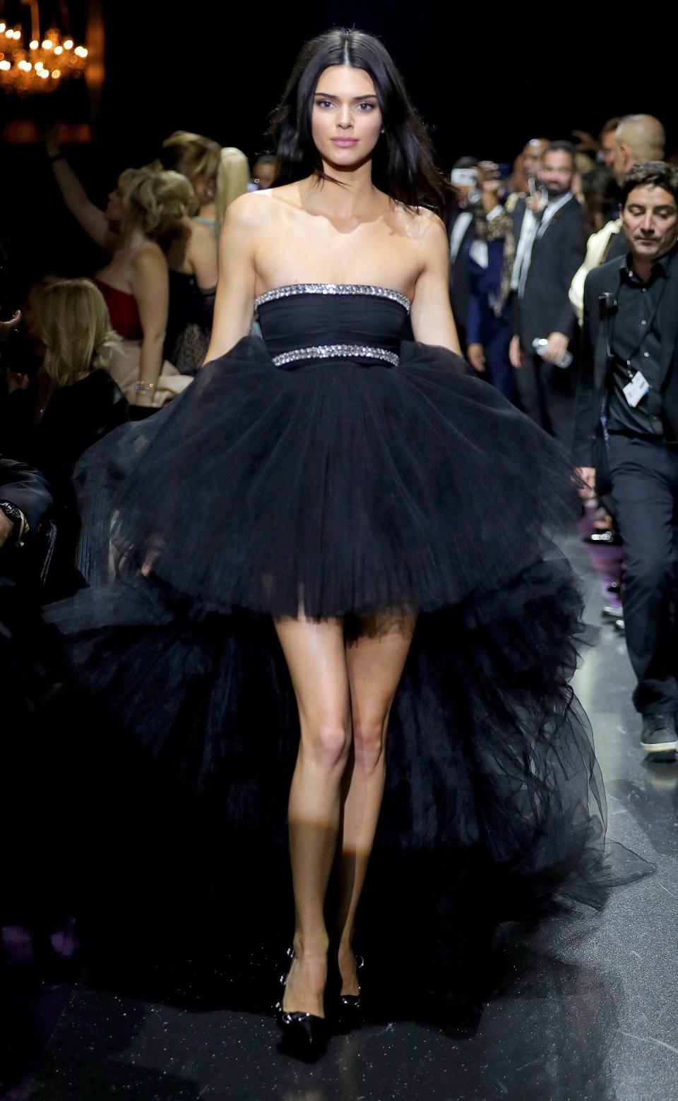 Kendall takes a spin down the runway during the amfAR Cannes Gala in a strapless tulle gown with high-low hem. 