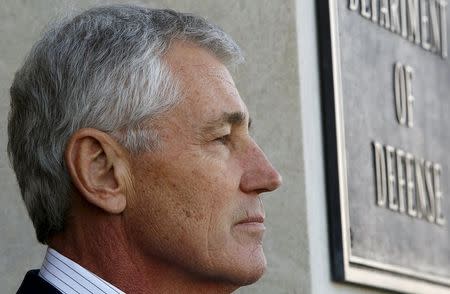 Then-U.S. Secretary of Defense Chuck Hagel stands outside the Pentagon during an arrival honor cordon in Washington, in this February 11, 2015 file photo.REUTERS/Gary Cameron/Files