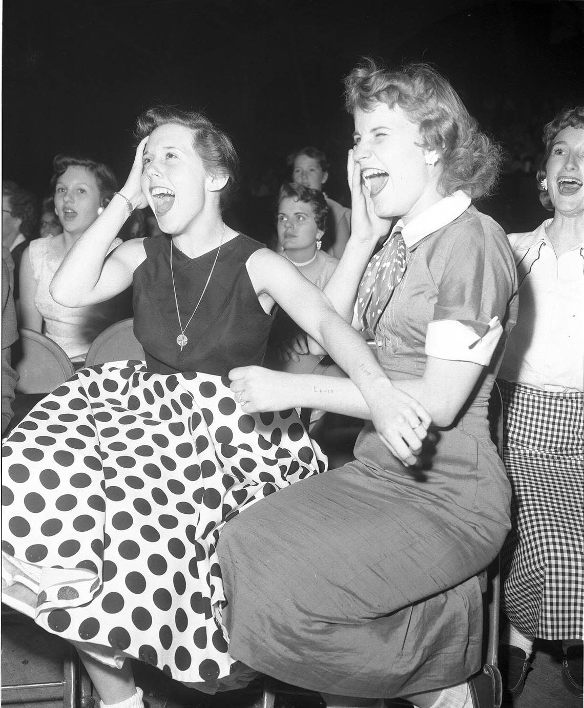 April 20, 1956: Georgiana Blaylock, left, and Dolores Orms, both 16 from Dalla, with “Elvis” carved into their arms at his show in the Fort Worth Northside Coliseum