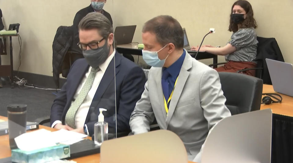 In this image from video, defense attorney Eric Nelson, left, and defendant, former Minneapolis police officer Derek Chauvin listen to Hennepin County Judge Peter Cahill read instructions to the jury before closing arguments, Monday, April 19, 2021, in the trial of Chauvin at the Hennepin County Courthouse in Minneapolis. Chauvin is charged in the May 25, 2020 death of George Floyd. (Court TV via AP, Pool)