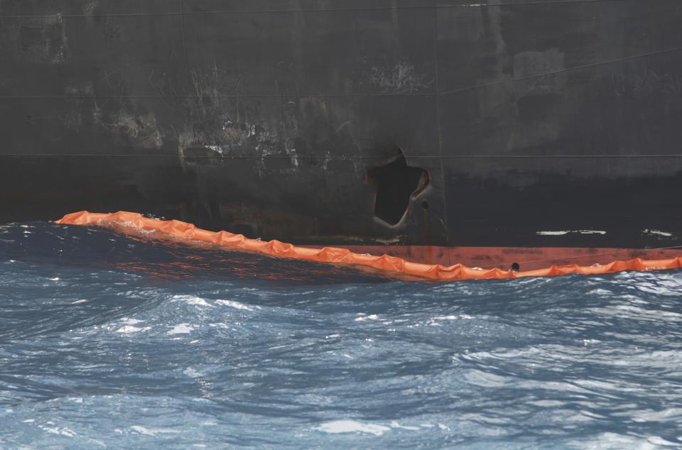 A hole the U.S. Navy says was made by a limpet mine is seen on the damaged Panama-flagged, Japanese owned oil tanker Kokuka Courageous, anchored off Fujairah, United Arab Emirates, during a trip organized by the Navy for journalists, on a Wednesday, June 19, 2019. The limpet mines used to attack the oil tanker near the Strait of Hormuz bore "a striking resemblance" to similar mines displayed by Iran, a U.S. Navy explosives expert said Wednesday. Iran has denied being involved. (AP Photo/Fay Abuelgasim)