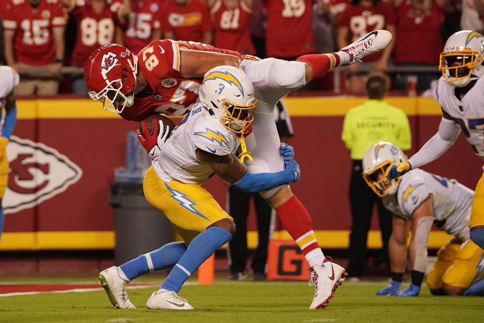 Kansas City Chiefs tight end Travis Kelce (87) is brought down by Los Angeles Chargers safety Derwin James Jr. during the Chiefs 27-24 win on "Thursday Night Football."