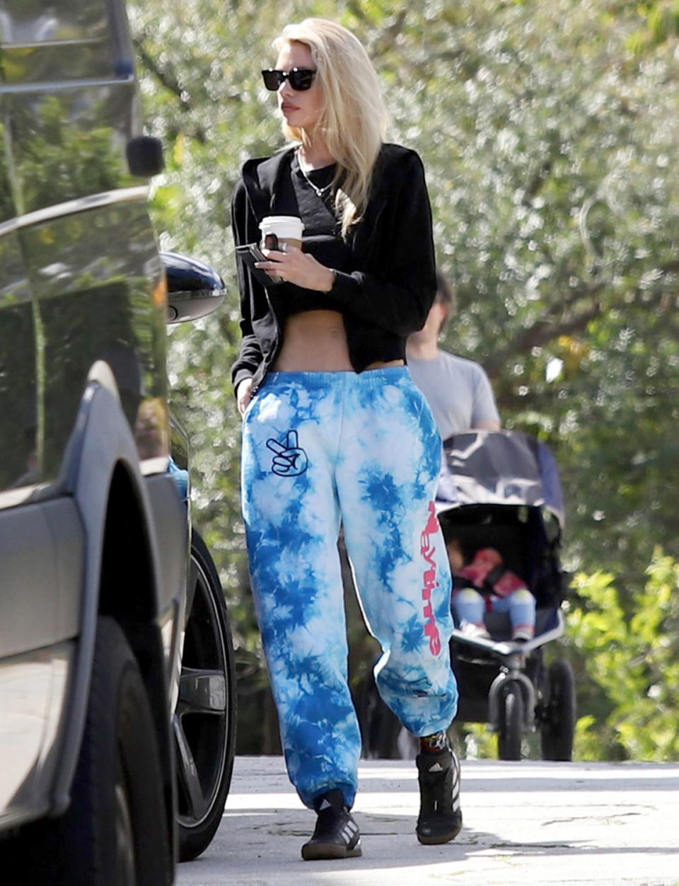 <p>Stella Maxwell wears a black cropped T-shirt and tie-dye pants to make a quick coffee run on Thursday in L.A.</p>