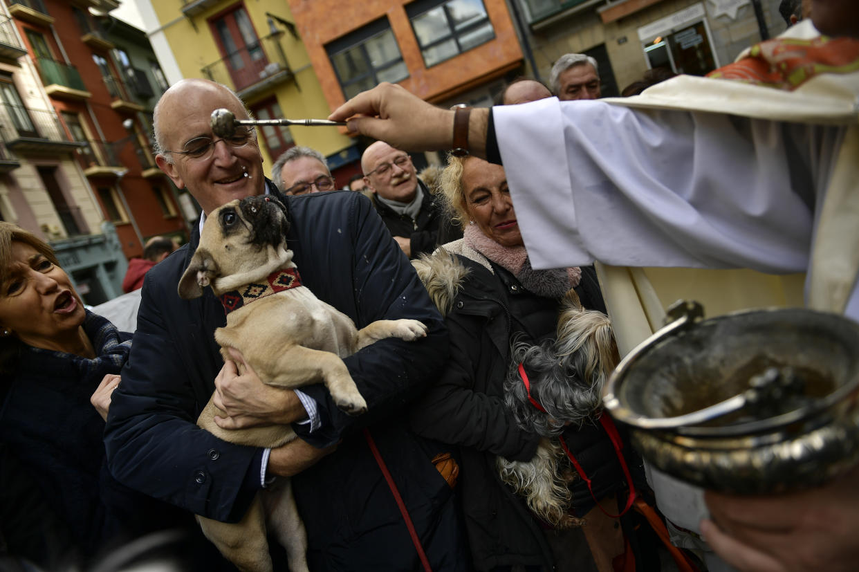 A priest blesses pets outside San Nicolas Church during the feast of St. Anthony, Spain’s patron saint of animals, in Pamplona on Jan. 17, 2019. (Photo: Alvaro Barrientos/AP)