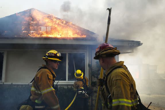 Firefighters put out a fire burning a home in Ventura.