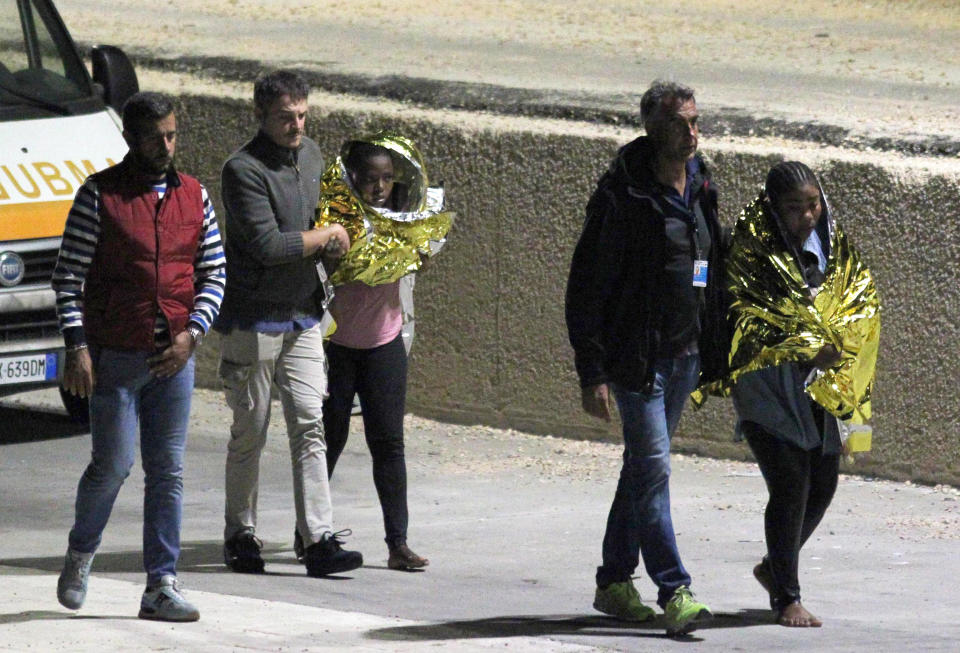 Migrants arrive in the Lampedusa harbor, Italy, early Monday, Oct. 7, 2019. The Italian Coast Guard says at least nine people have died when a migrant boat capsized near the island of Lampedusa as they were about to be rescued. Twenty-two people were saved. (Pasquale Claudio Montana Lampo/ANSA via AP)