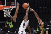 South Florida's Michael Durr, right, fouls Virginia Tech's Nahiem Alleyne, center, as South Florida's David Collins, left, defends in the first half of an NCAA college basketball game, Sunday, Nov. 29, 2020, in Uncasville, Conn. (AP Photo/Jessica Hill)