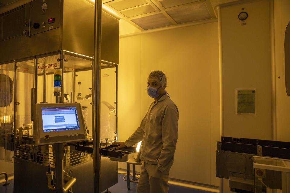 A lab technician works at the Eva Pharma facility in Cairo, Egypt, Sunday, July 12, 2020. Eva Pharma, a leading Egyptian pharmaceutical company is producing two drugs used in the treatment of COVID-19 patients -- remdesivir for severe cases in intensive care, and avipiravir indicated for moderate cases. (AP Photo/Nariman El-Mofty)