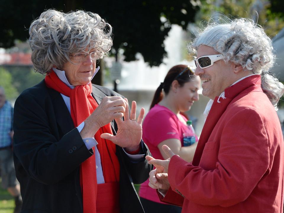 Tom New, left, WQLN president and CEO, dressed as Beethoven, speaks with Brian Hannah, host of radio show "Classics with Brian Hannah," dressed as Mozart, just before the Erie Philharmonic Beat Beethoven 5K race in Erie in 2018.