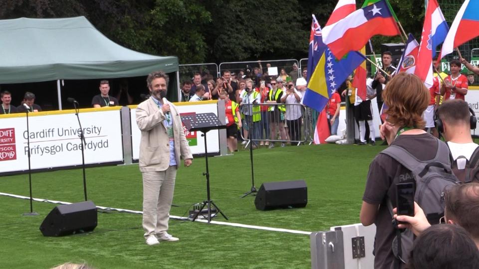 Michael Sheen delivers an address at the opening of the 2019 Homeless World Cup in Cardiff, Wales (Credit: 