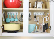 <body> <p>Steal a few hooks from the <a rel="nofollow noopener" href=" http://www.bobvila.com/slideshow/start-fresh-10-essentials-for-an-organized-entryway-48932?bv=yahoo" target="_blank" data-ylk="slk:entryway;elm:context_link;itc:0;sec:content-canvas" class="link ">entryway</a>, add a dash of inspiration, and you have all the makings of a baker-friendly cabinet. Start by mounting a key rail or self-stick plastic hooks to the back of a cabinet. Then, hang measuring cups and spoons, whisks, and mixer attachments to create an organizational oasis fit for a pastry chef.</p> <p><strong>Related: <a rel="nofollow noopener" href=" http://www.bobvila.com/slideshow/7-clever-ways-for-hooks-to-streamline-your-life-48763?bv=yahoo" target="_blank" data-ylk="slk:7 Clever Ways for Hooks to Simplify Your Life;elm:context_link;itc:0;sec:content-canvas" class="link ">7 Clever Ways for Hooks to Simplify Your Life</a> </strong> </p> </body>