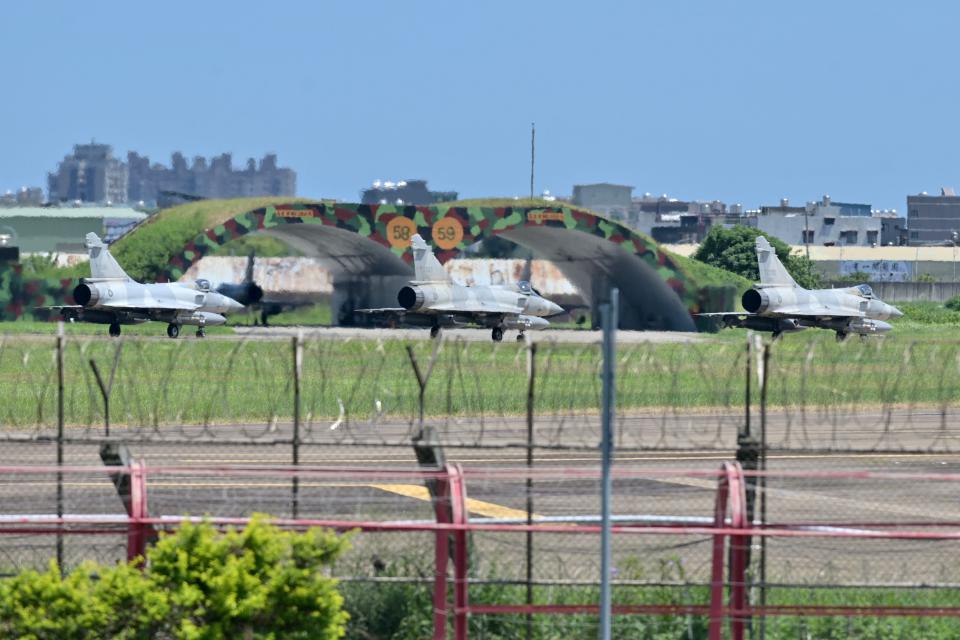 Three French-made Mirage 2000 fighter jets taxi on a runway in front of a hangar at the Hsinchu Air Base in Hsinchu on 5 August 2022 (AFP via Getty Images)
