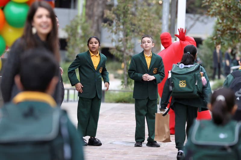 Children return to campus for the first day of New South Wales public schools fully re-opening in Sydney