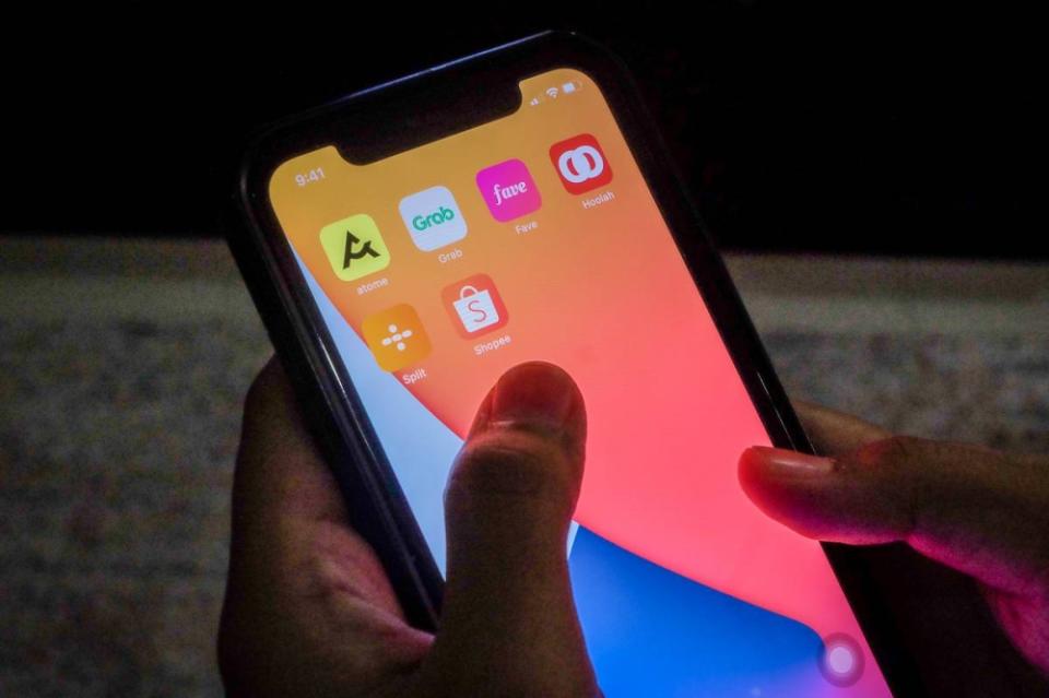 Icons of buy now pay later apps are arranged, from top left, Atome, Grab, Fave, Hoolah, Split and Shoope on an iPhone in Shah Alam June 23, 2022. — Picture by Yusof Mat Isa