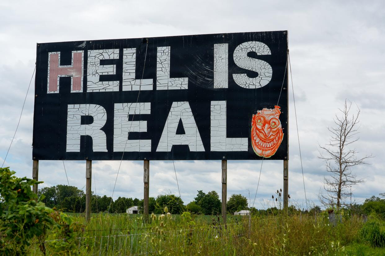 The original Hell is Real sign is on Interstate 71 between Cincinnati and Columbus, Ohio on Tuesday, Aug. 15, 2023 in Mount Sterling, Ohio. A painted devil smile on one side of the sign.