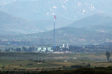 A North Korean flag flutters on top of a tower at the propaganda village of Gijungdong in North Korea, in this picture taken from Tongil observatory in Paju, South Korea August 29, 2017. Lim Byung-Shik/Yonhap/via REUTERS