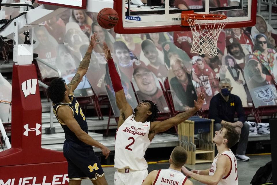 Michigan's Eli Brooks shoots over Wisconsin's Aleem Ford during the second half of an NCAA college basketball game Sunday, Feb. 14, 2021, in Madison, Wis. (AP Photo/Morry Gash)