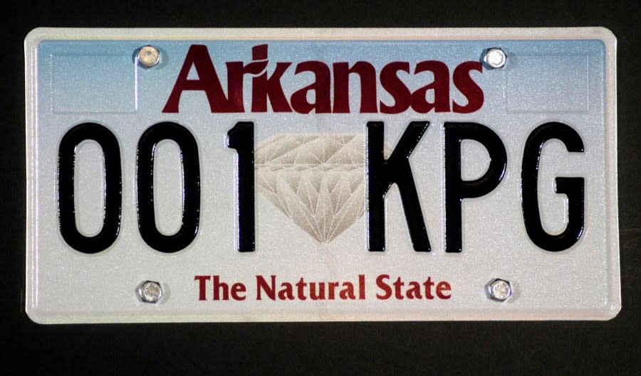 A new Arkansas license plate is seen during a news conference, Thursday, March 9, 2006, at the Capitol in Little Rock, Ark. The new plate features a diamond in the center, representing the state’s diamond industry. The change is the first major overhaul of the license plate since 1996. (AP Photo/Mike Wintroath)