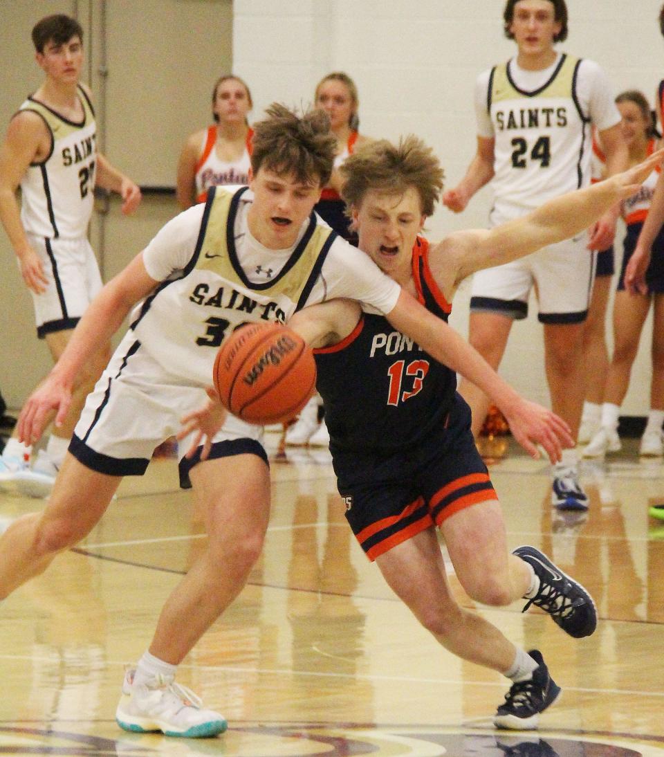 Drew Wayman of Pontiac, right, battles with Trey Eller of Central Catholic for the ball Friday at BCC.