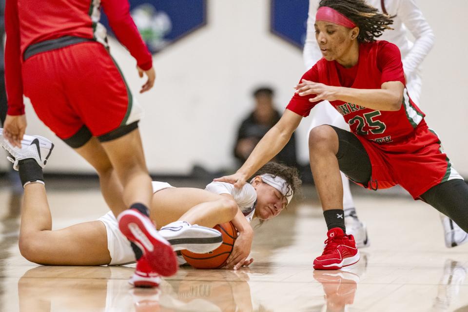 Lawrence North High School sophomore Ke'Adriah Butler (25) goes after a ball being recovered by Lawrence Central High School junior Mariah Garrett (4) during the first half of an IHSAA Class 4A Sectional semi-final basketball game, Friday, Feb. 2, 2024, at Cathedral High School.