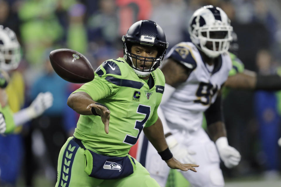 Seattle Seahawks quarterback Russell Wilson (3) pitches out to tight end Will Dissly during the second half of the team's NFL football game against the Los Angeles Rams on Thursday, Oct. 3, 2019, in Seattle. (AP Photo/Stephen Brashear)