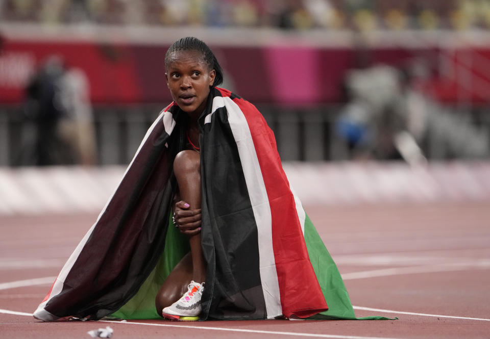 FILE - Faith Kipyegon, of Kenya celebrates after winning gold after the final of the women's 1,500-meters at the 2020 Summer Olympics, Friday, Aug. 6, 2021, in Tokyo, Japan. "We're trying to clean up our country," said Faith Kipyegon, the Kenyan middle-distance runner who broke three world records this year, has never failed a doping test, but was asked at a recent press conference - like many of her compatriots often are - to account for the more than 180 doping sanctions handed out to Kenyans since 2017. (AP Photo/Charlie Riedel, File)