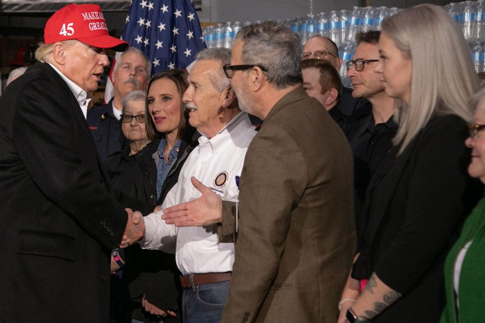 Former President Donald Trump shakes hands with guests after he spoke at the East Palestine Fire Department in East Palestine, Ohio, on February 22, 2023.