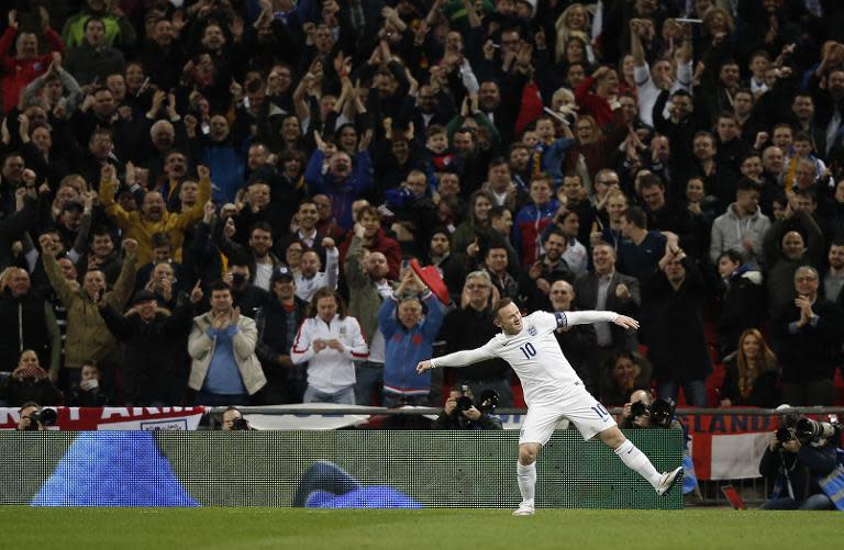 England's striker Wayne Rooney celebrates after scoring his team's first goal during a Euro 2016 Group E qualifying football match with Lithuania in London on March 27, 2015