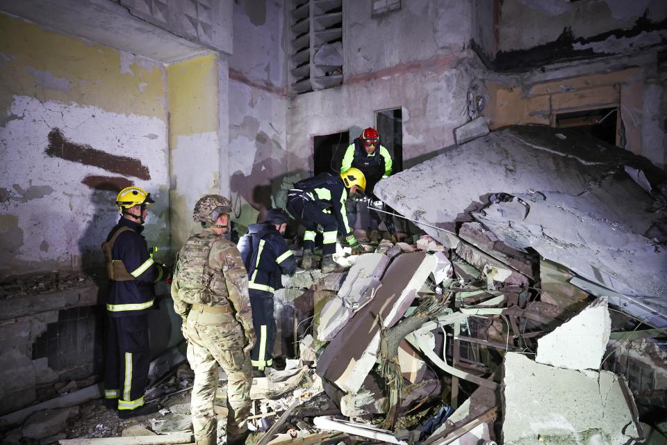 Ukrainian responders work at the sit of the overnight shelling (Anadolu via Getty Images)