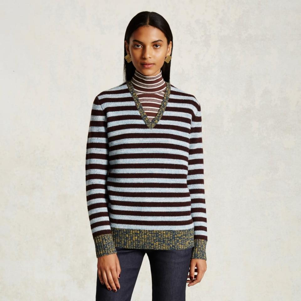 Embrace the geek-chic allure of layered striped sweaters — even better when one’s a T-neck, and one’s a V-neck.
