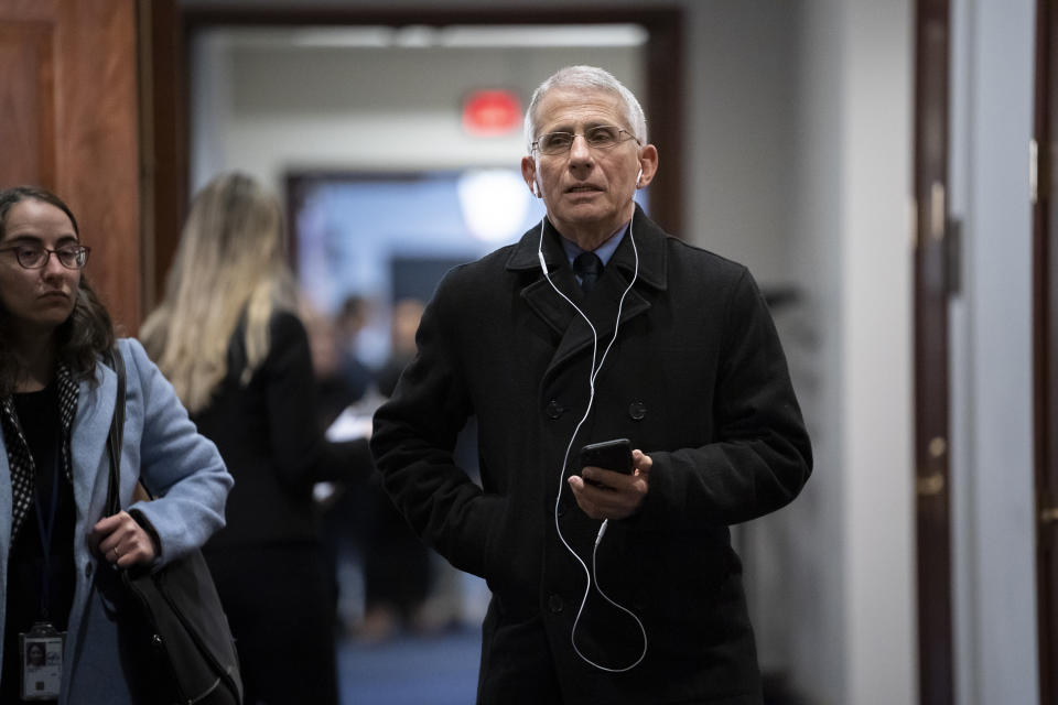 Anthony Fauci, director of the National Institute of Allergy and Infectious Diseases, takes a phone call outside a room on Capitol Hill where he and others from the president's coronavirus task force briefed members of the House of Representatives on the outbreak of the new respiratory virus sweeping the globe, in Washington, Friday, Feb. 28, 2020. (AP Photo/J. Scott Applewhite)