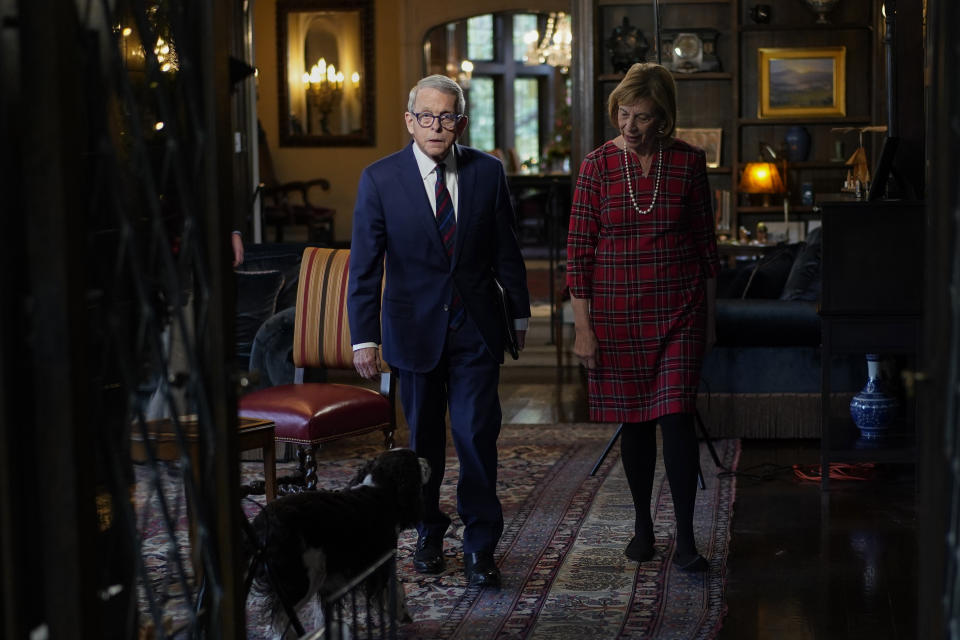 Ohio Gov. Mike DeWine, his spouse Fran, and their dog Dolly, arrive for an interview with The Associated Press at the Ohio Governor's Residence in Columbus, Ohio, Thursday, Dec. 21, 2023. (AP Photo/Carolyn Kaster)