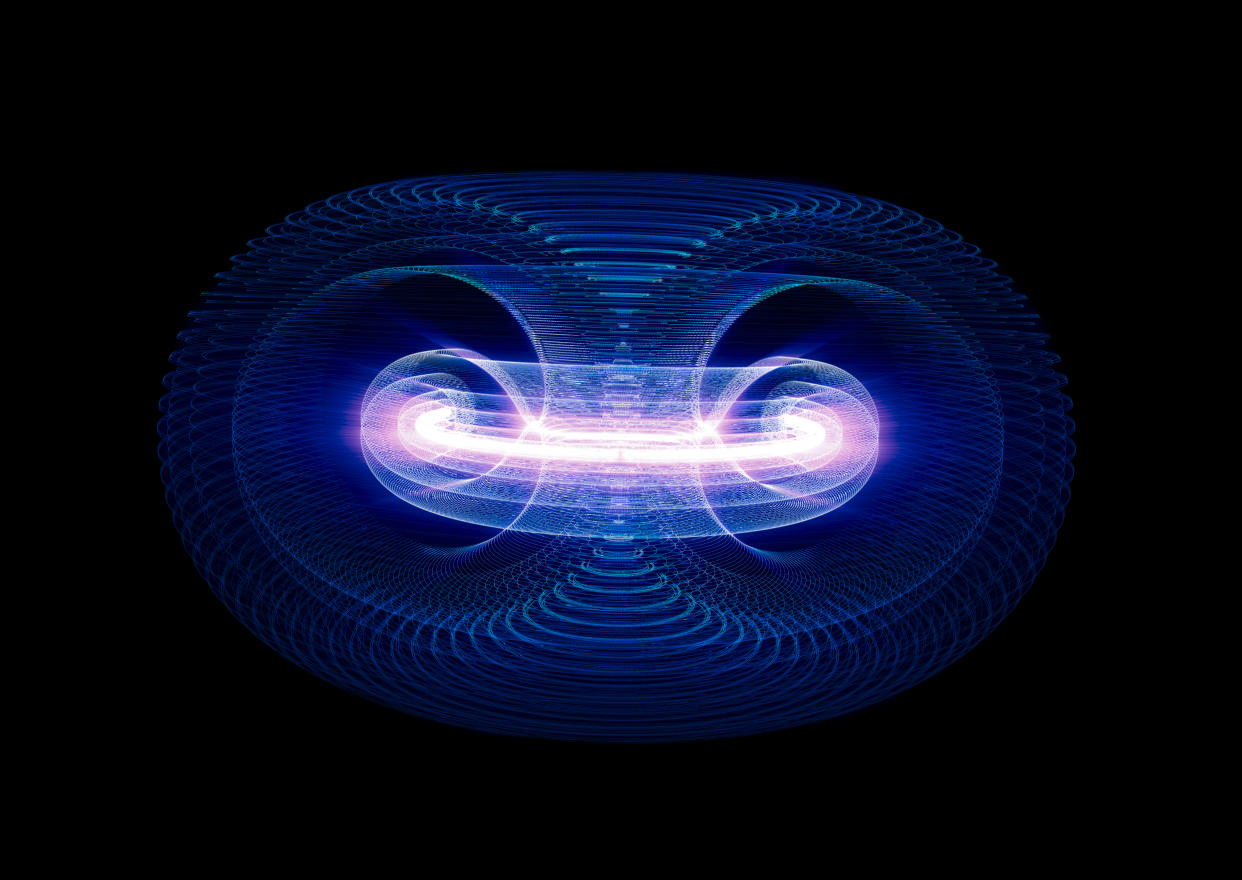 High Energy Particles Flow Through A Tokamak Or Doughnut-Shaped Device. Antigravity, Magnetic Field, Nuclear Fusion, Gravitational Waves And Spacetime Concept