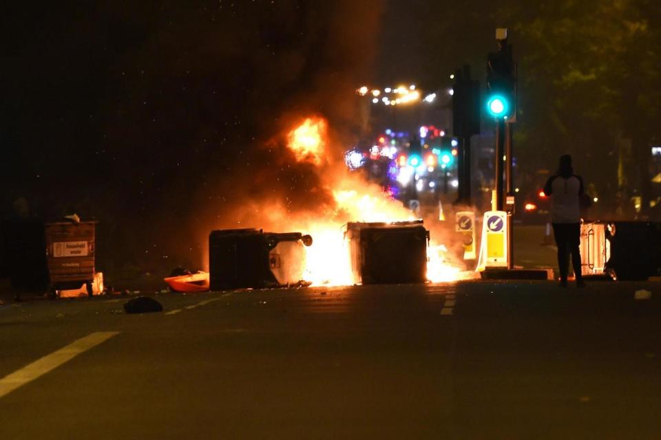 The road blockade was set on fire as the protest continued later into the evening. (PA)