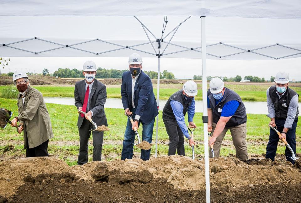 City of Muncie and state officials, including Indiana Gov. Eric Holcomb, center, and Mayor Dan Ridenour, second from left, attended a groundbreaking ceremony for a planned Canpack factory on Fuson Road.