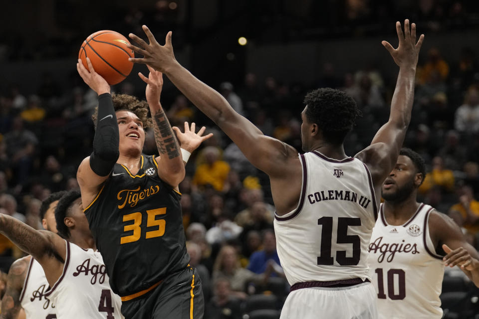 Missouri's Noah Carter shoots over Texas A&M's Henry Coleman III (15) during the second half of an NCAA college basketball game Wednesday, Feb. 7, 2024, in Columbia, Mo. (AP Photo/Jeff Roberson)