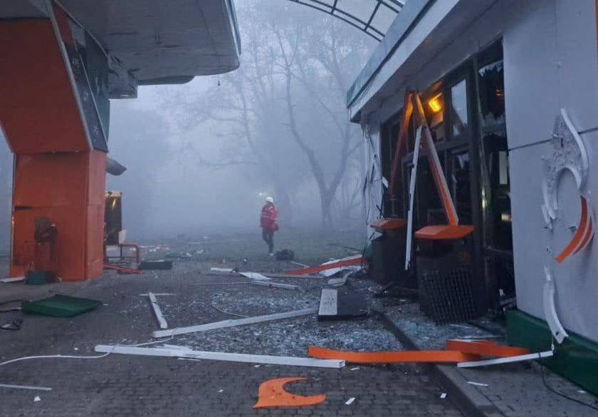 A rescuer is seen at a compound of a petrol station damaged by a Russian missile strike, amid Russia's attack on Ukraine, in Dnipro (via REUTERS)