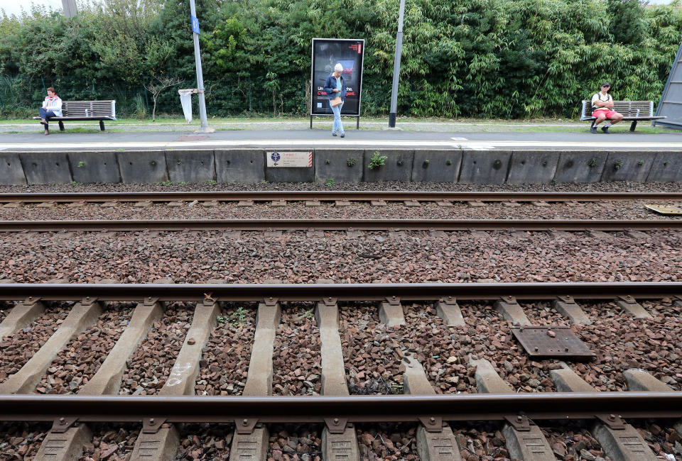 Travelers wait for trains on the platform of the station of Saint Jean de Luz, southwestern France, Friday, Oct.18, 2019. A wildcat strike is disrupting train travel around France, as railway workers demand better security after a recent accident. (AP Photo/Bob Edme)