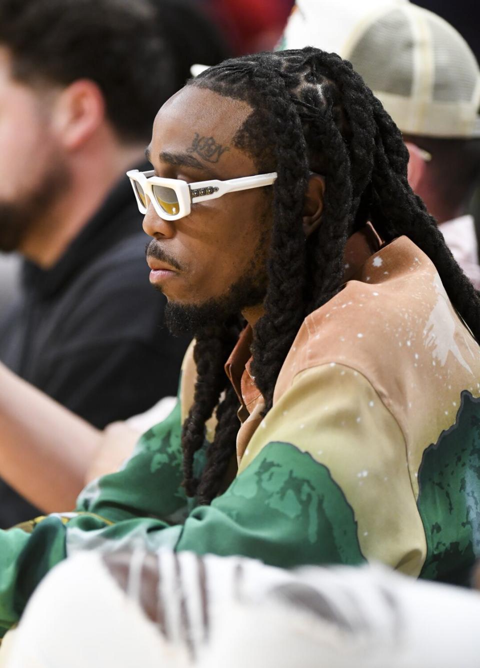 Quavo wears white-framed glasses