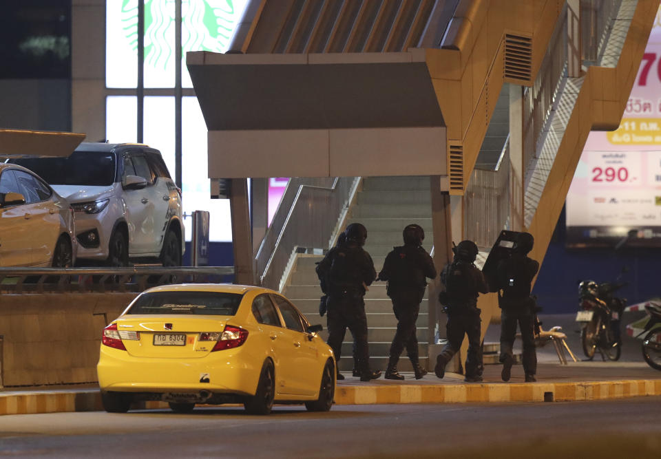 A group of armed commando soldiers are seen outside Terminal 21 Korat mall, in Nakhon Ratchasima, Thailand on Sunday, Feb. 9, 2020.A soldier who holed up in a popular shopping mall in northeastern Thailand shot multiple people on Saturday, killing at least 20 and injuring 31 others, officials said. (AP Photo/Sakchai Lalitkanjanakul)