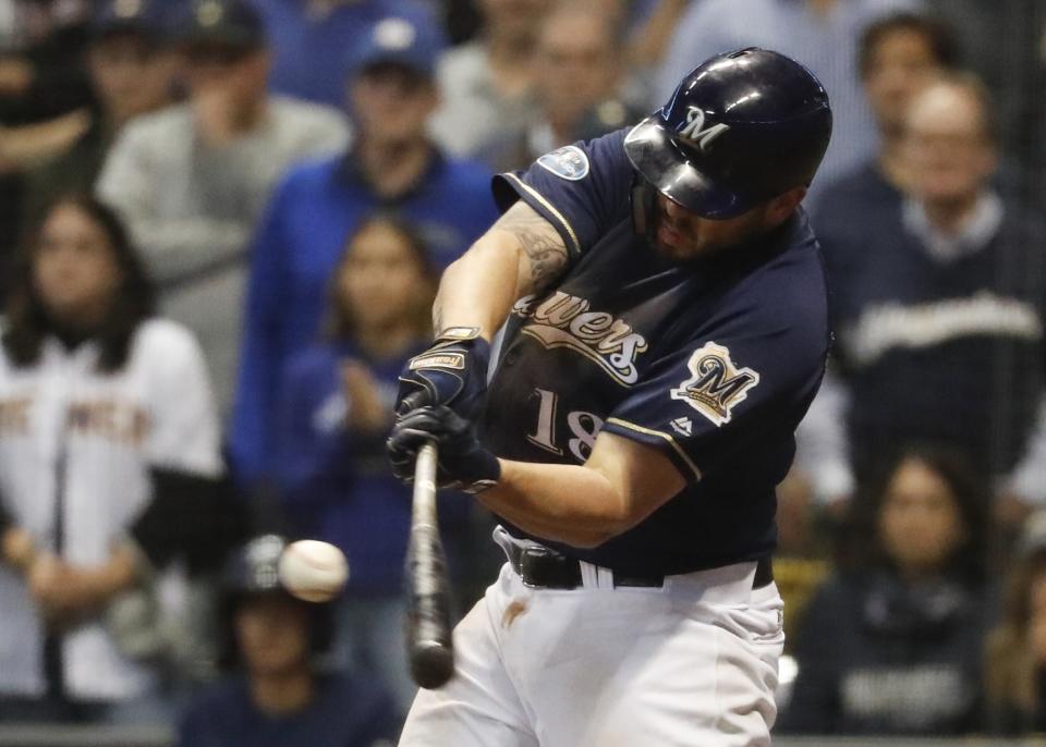 Milwaukee Brewers' Mike Moustakas hits an RBI single during the eighth inning of Game 2 of the National League Divisional Series baseball game against the Colorado Rockies Friday, Oct. 5, 2018, in Milwaukee. (AP Photo/Jeff Roberson)